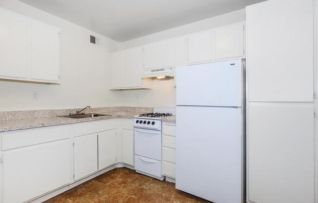 a white refrigerator freezer sitting inside of a kitchen