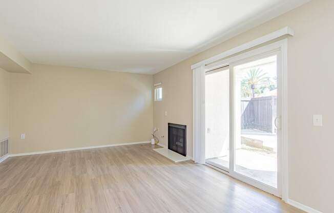 a living room with a fireplace and a sliding glass door