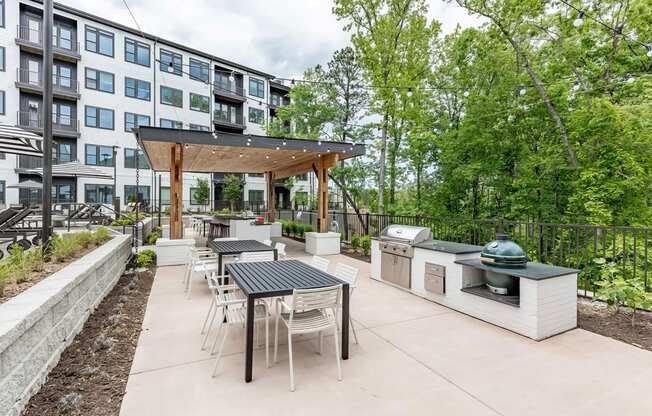 Fun and beautiful outdoor kitchen and seating areas with standard and ceramic grills at Novel Cary