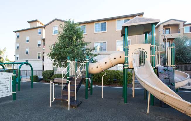 San Jose, CA Apartments for Rent- Aviara- Playground, Padded Area, Building Exterior, and Trees
