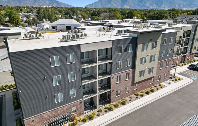 an aerial view of an apartment complex with mountains in the background