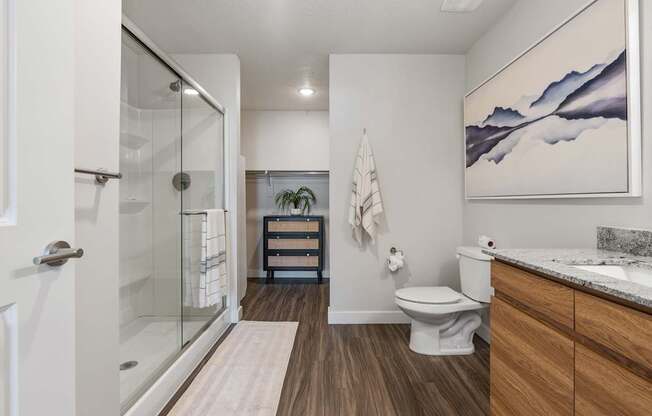 a bathroom with a glass shower and a toilet