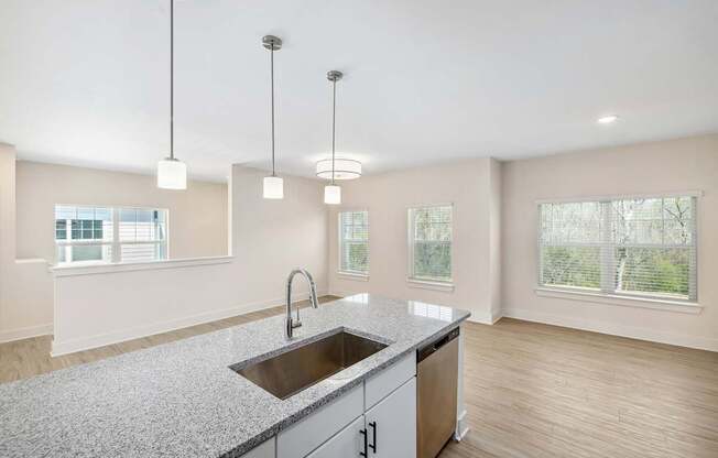 A kitchen with a granite countertop and a sink.