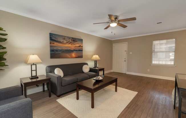 a living room with a couch and a ceiling fan