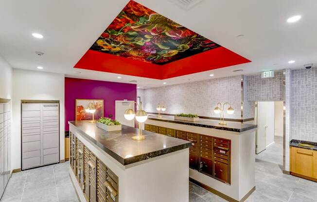 A kitchen with a purple wall and a mural of a flower on the ceiling.
