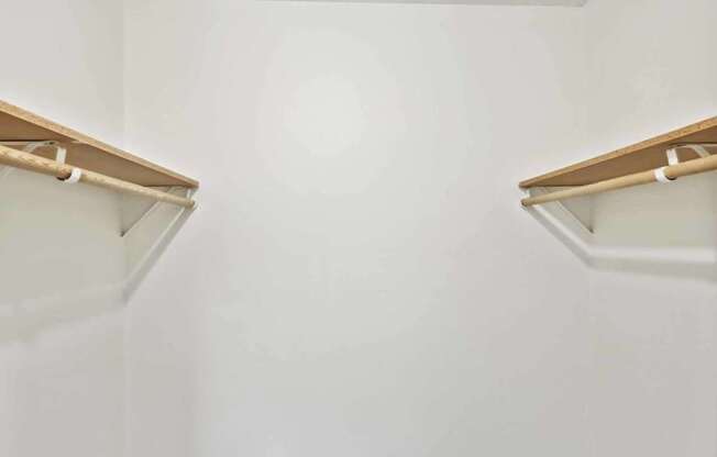 A small, empty room with a brown carpet and white walls.
