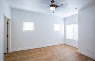 Colton Apartments   bedroom with wood floors and ceiling fan and windows