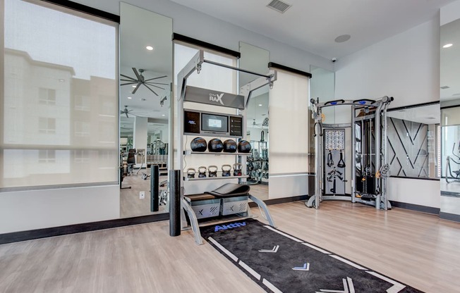 a home gym with exercise equipment and glass doors