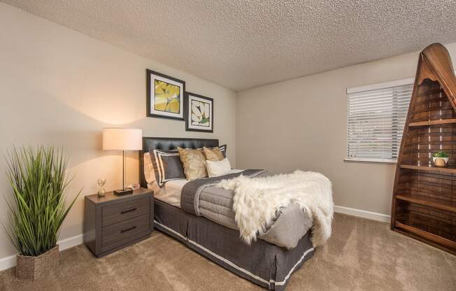 a bedroom with a bed and a window at Lodge of Overland Park Apartments, Overland Park , Kansas