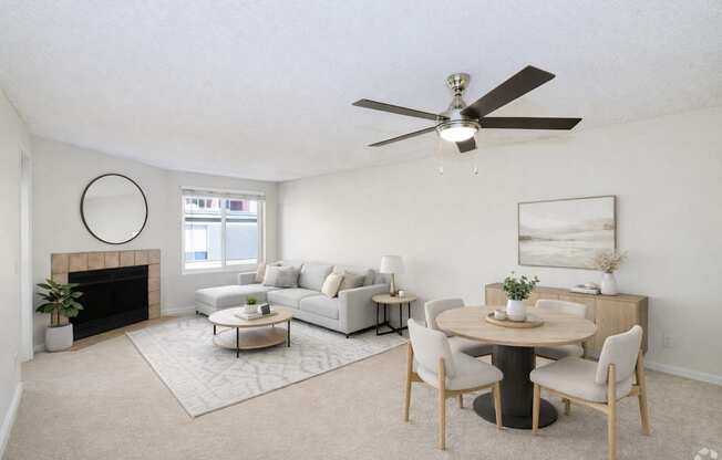 A living room with a fireplace, couch, and dining table.