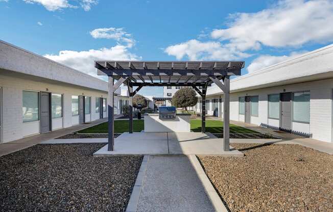 a courtyard with awnings and a bench in the middle