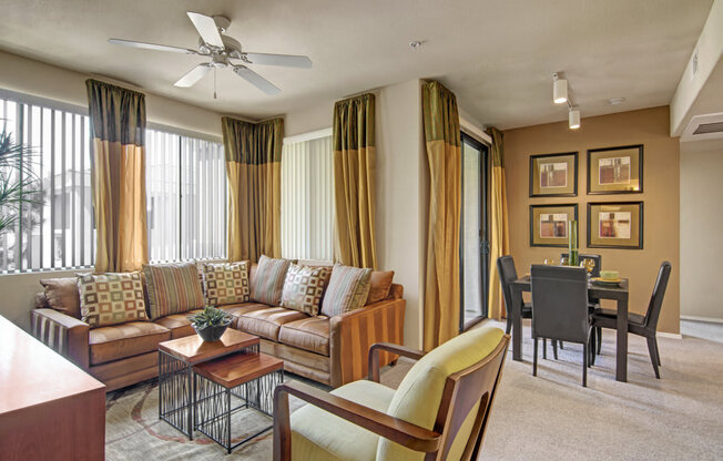 a living room with a couch chairs and a table