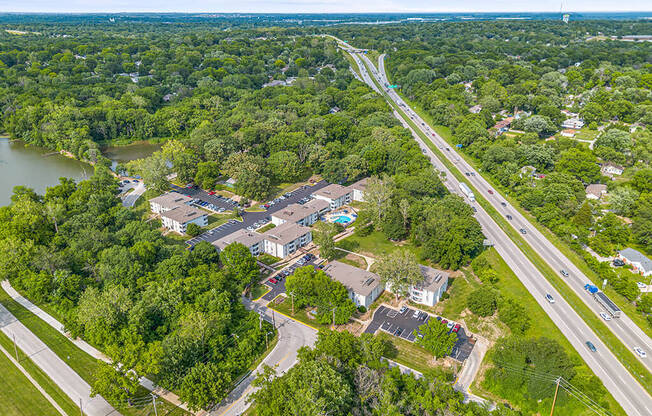 a aerial view of a neighborhood of houses and a highway