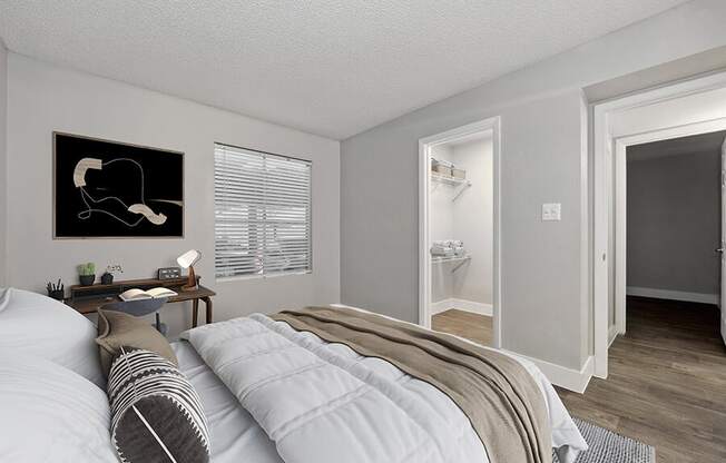 Model Bedroom with Wood-Style Flooring and Walk In Closet at Crystal Creek Apartments located in Phoenix, AZ.