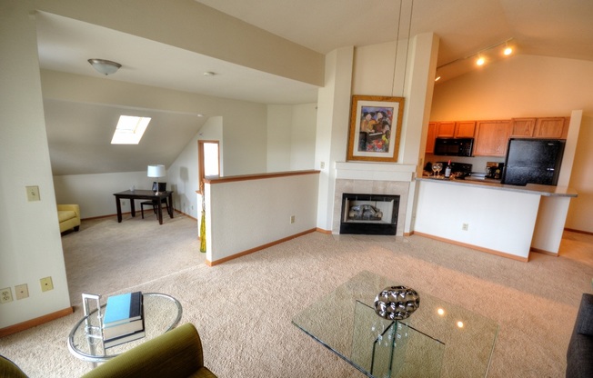 a living room with a fireplace and a glass table