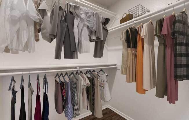 a closet with a rack of clothes hanging on the wall