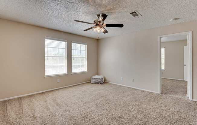 spacious bedroom with carpet & ceiling fan  at Arbors Of Cleburne, Cleburne, 76033