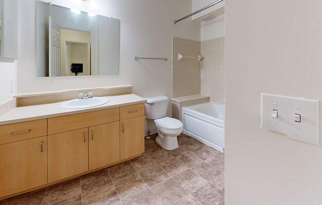 A bathroom with a sink, toilet, and whirlpool bathtub at Foxwood and The Hermitage, Michigan