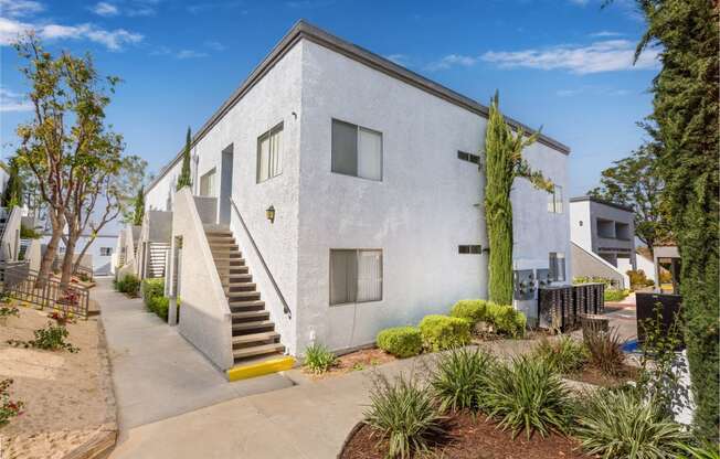 a white building with stairs in front of it