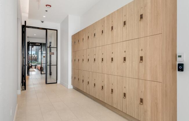 a long row of wooden lockers in a hallway of a building  at Cassidy on Canal, Chicago