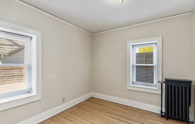 the living room  with two windows and a radiator