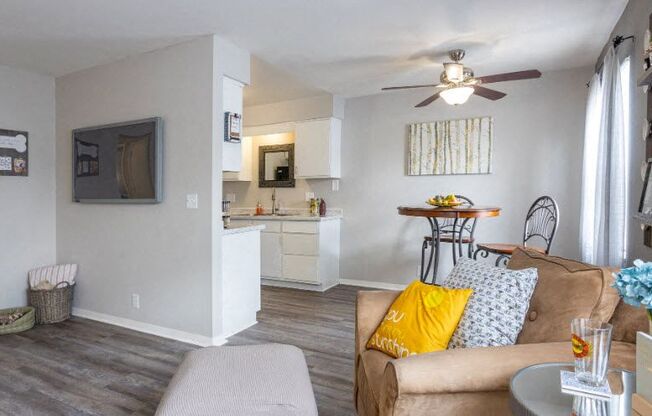 a living room with a couch and a ceiling fan