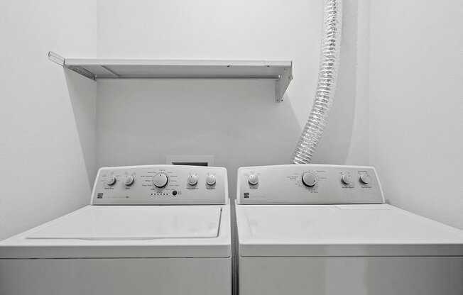 two white washing machines in a white room