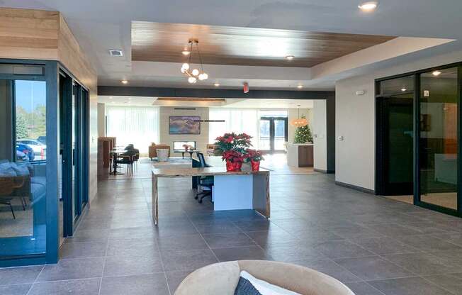 the front lobby area with a large leasing desk between two offices