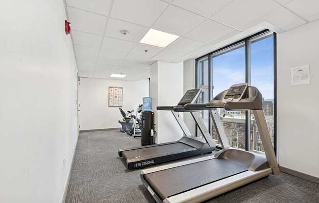 A gym with treadmills and a weight machine.