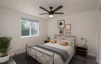 a bedroom with a bed and a ceiling fan