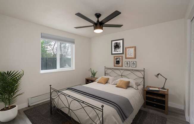 a bedroom with a bed and a ceiling fan