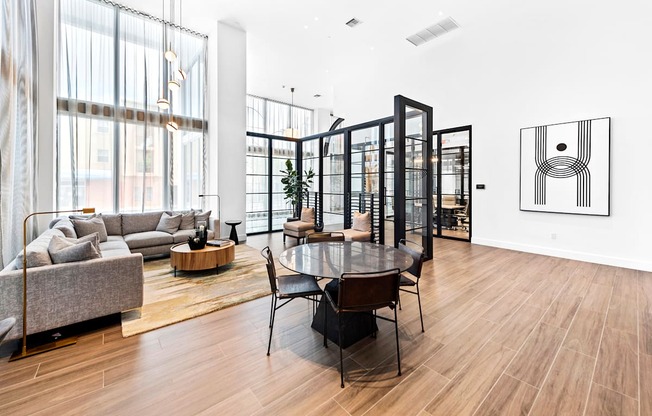 a living room with white walls and hardwood floors