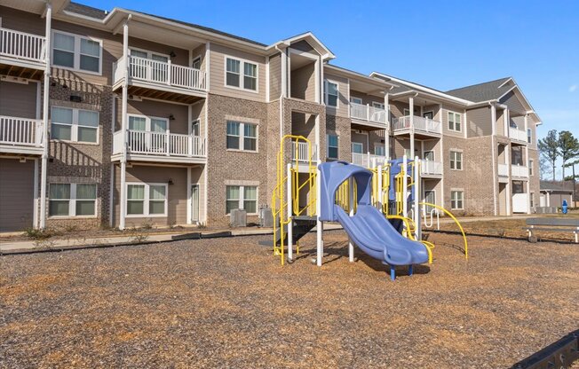 A playground with a slide at Aurora apartments