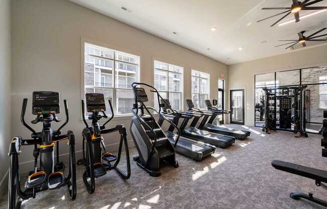 A gym with treadmills, elliptical machines, and stationary bikes. at The One at Spartanburg, Spartanburg, South Carolina