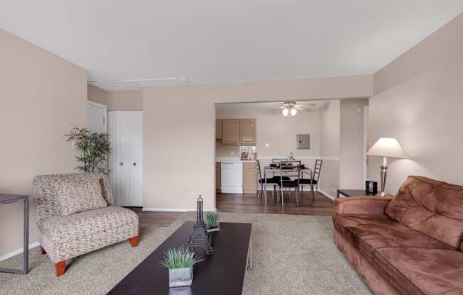 a living room with a leather couch and a coffee table at St Charles Square Apartments, Carol Stream, IL
