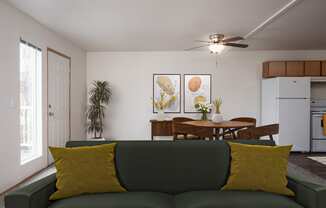 a living room with a couch and a table and a ceiling fan