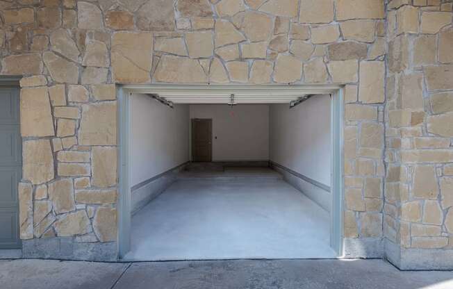 a garage with an open door and a concrete floor