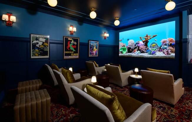 A room with a blue wall and a large screen on the wall.