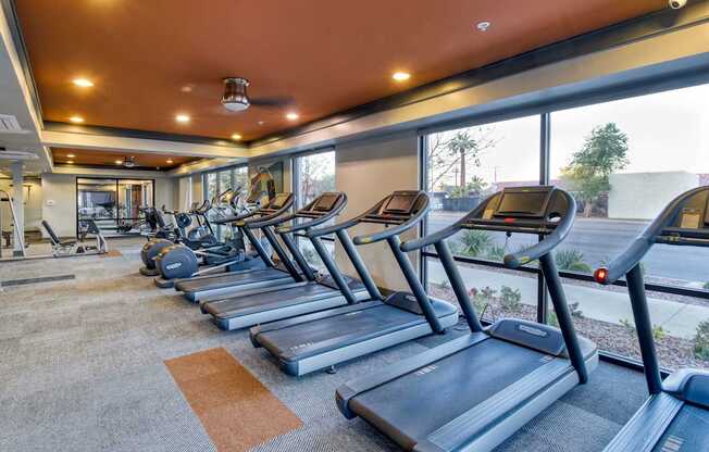 A gym with treadmills and other equipment.