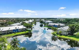 an aerial view of a flooded neighborhood with palm trees and houses