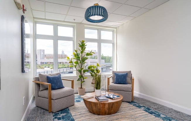 a lounge area with two chairs and a coffee table