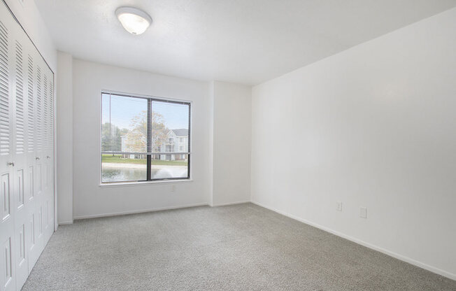 bedroom with a large window and carpet at North Pointe Apartments in Elkhart, IN