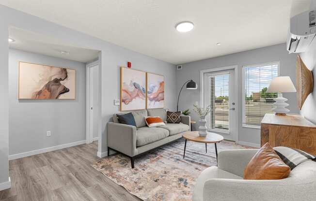 a living room with grey walls and a couch and a table