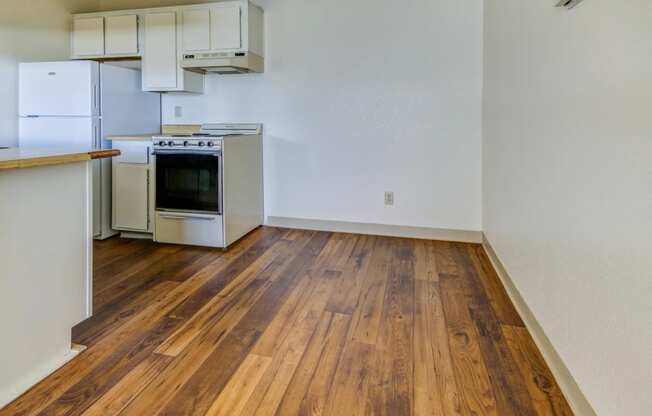 a kitchen with a stove and a refrigerator