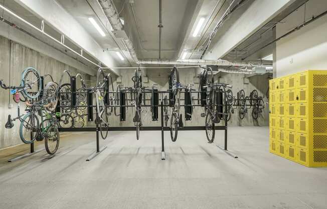 a room full of bikes on racks in a parking garage