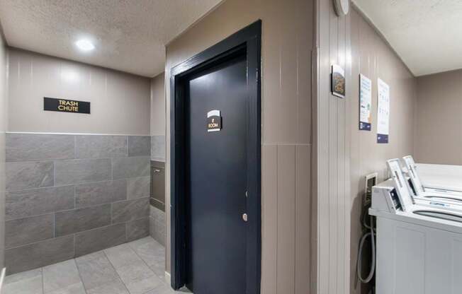 One of the clothes care centers near a trash chute at Cambridge Court Apartments in Lake Highlands, Dallas, TX.