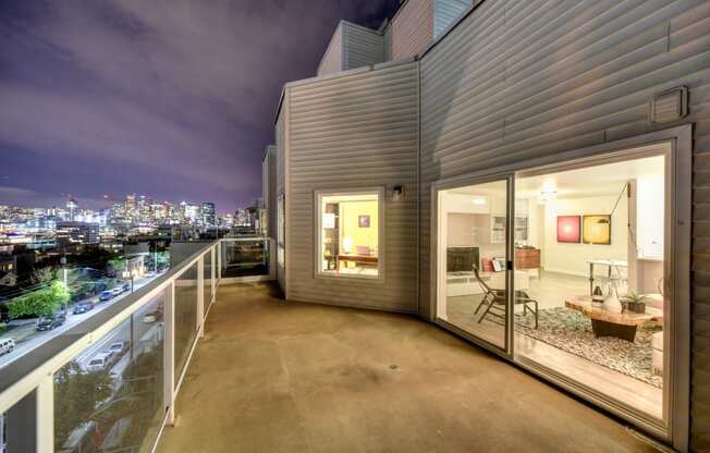 Private Balcony at Night with View of Living Room and Street