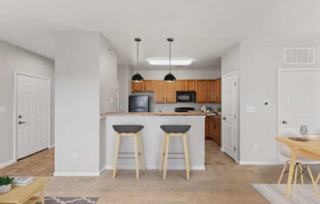 a kitchen with a breakfast bar and stools