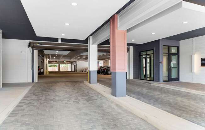 A long hallway with a brick floor and a white ceiling.