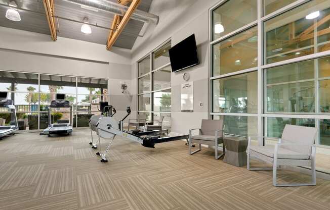 a resident fitness center with a treadmill and elliptical machine